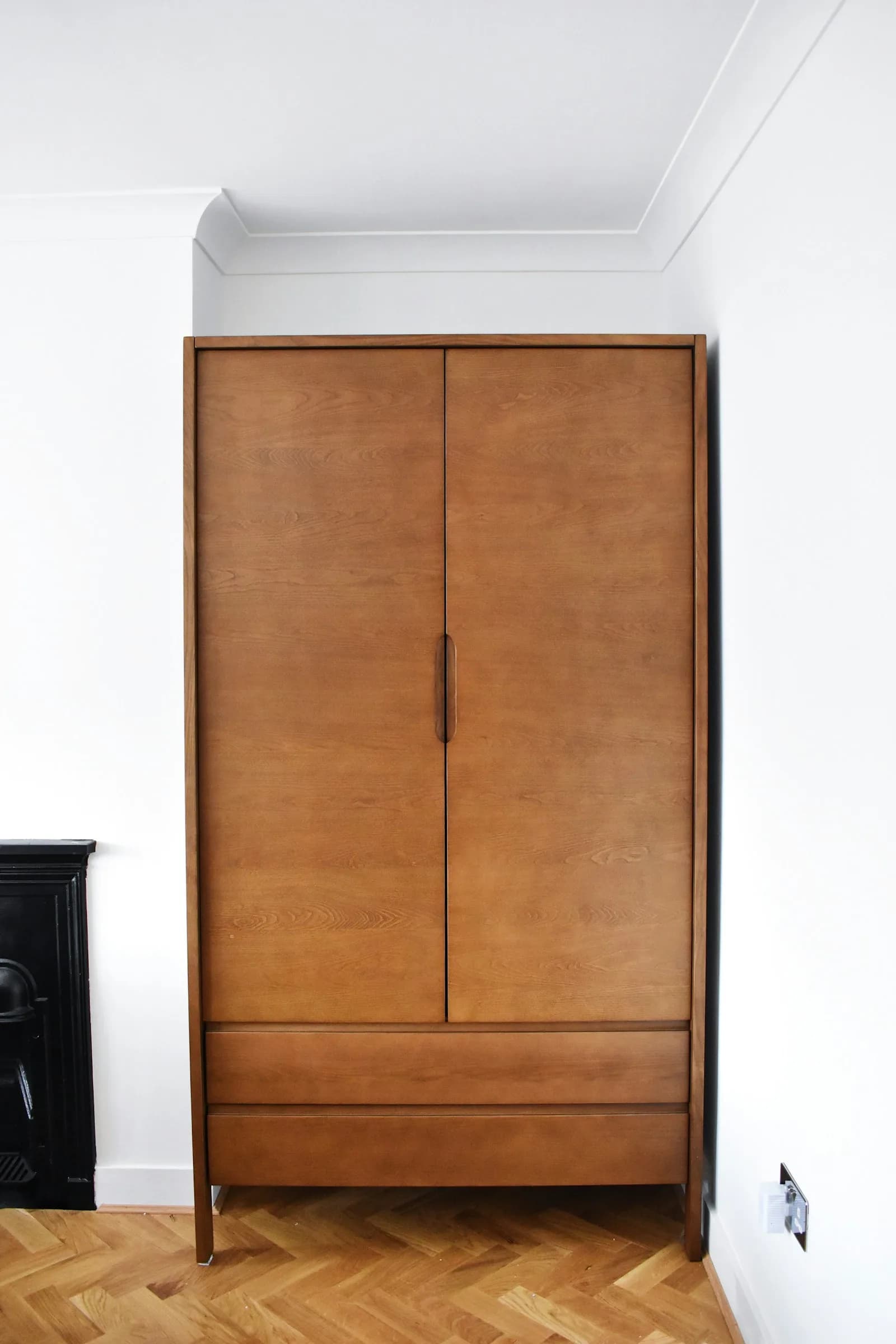 Walk-in wardrobe with fluted timber shutters and integrated lighting